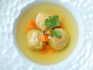 Tasty Jewish matzoh balls soup in dish, closeup