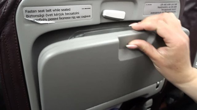 Female Open Airplane Tray Table On Seat Back And Prepare For Lunch