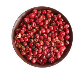Bowl of red peppercorns isolated on white, top view