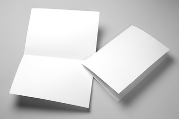 Blank half-folded booklet, postcard, flyer or brochure mockup template on gray background