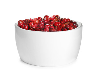 Bowl of red peppercorns isolated on white
