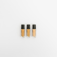 Bottles of liquid foundation on white background