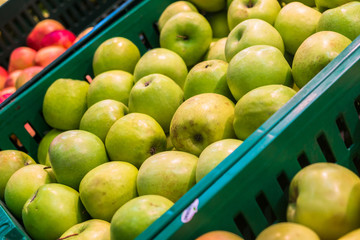 delicious juicy apples on the supermarket counter