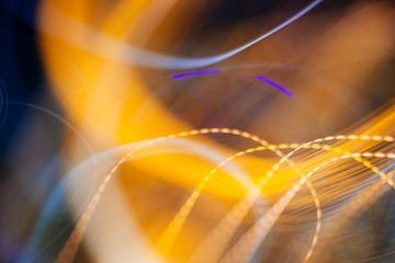 Colorful pattern of orange and blue dynamic lines of light. Modern blurred background. Art concept of lighting effects.