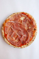 pizza base with ham (prosciutto di parma) isolated on white background