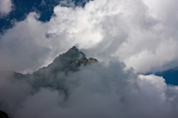Panoramic view of the mountain peaks shrouded in clouds.