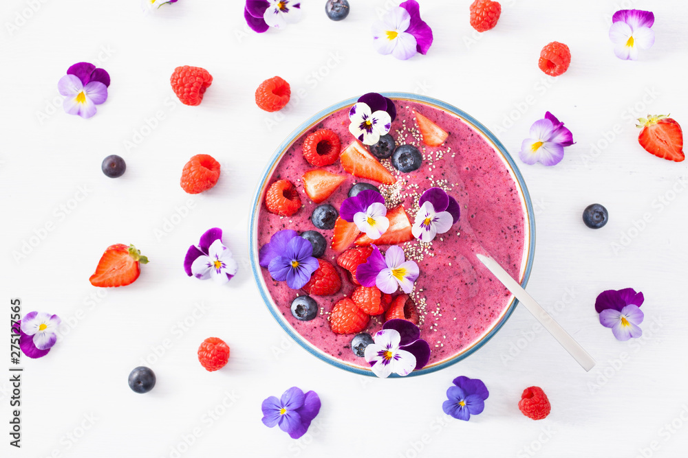 Wall mural healthy summer berry smoothie bowl with flowers and chia seed