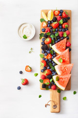 fruit and berry platter over white. blueberry, strawberry, raspberry, blackberry, watermelon