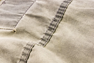 clothing items stonewashed cotton fabric texture with seams, clasps, buttons and rivets, macro