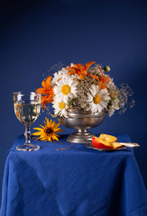 Still life with bright summer flowers on a blue background
