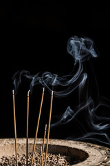 Incense sticks burning with smoke