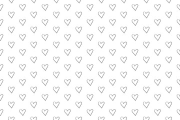 Hand drawn background with hearts. Seamless grungy wallpaper on surface. Abstract texture with many signs. Lovely pattern. Print for design. Black and white illustration