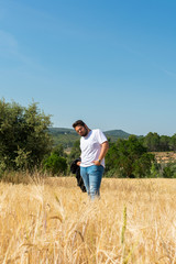 Overweight man in a field in summer