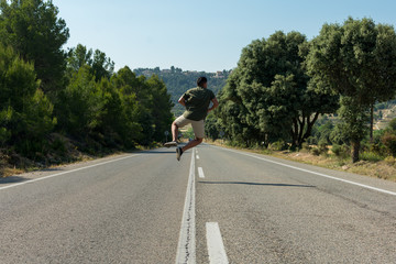 Man jumping on the empty road. Globetrotter