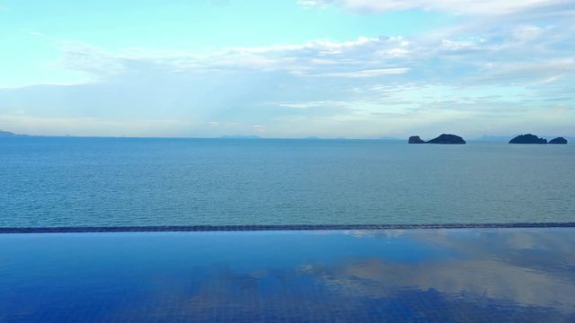 Beachside infinity pool overlooking sea and islands