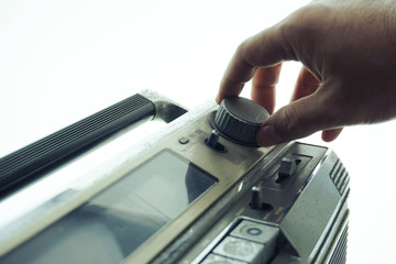 Hand adjust signal tuning of vintage cassette tape dial.