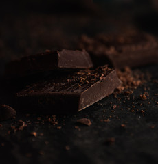Delicious dark bitter chocolate over a black background
