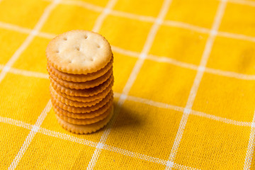 Pile Column. Cookie cracker. yellow tablecloth