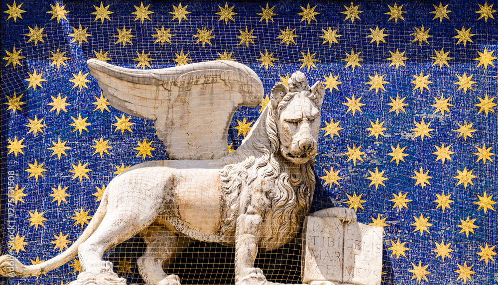 Wall mural statue of winged lion on the clock tower at piazza di san marco in venice, italy