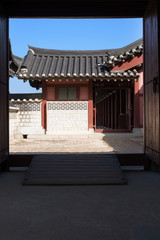 Korean traditional tiled roof and stone wall, ancient architecture of palace.