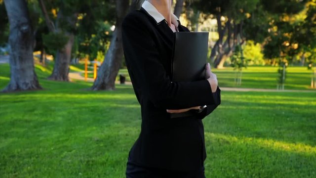 Attractive caucasian business woman looks at the camera with an expression of pride and confidence while giving a big smile. Slow motion.