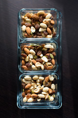 Raisins, peanuts and pistachio in elegant glass bowls