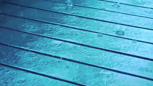 Wooden Deck Raindrops Falling ,Wet Blue Patio Surface Footage 4K Real Video