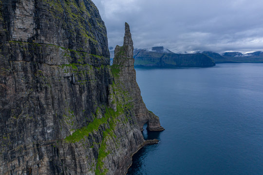 Aerial view of Trollkonufingur, Witch's Finger, Fjord under the clouds in Vagar, Faroe Islands