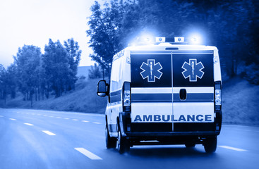 Ambulance van on highway with flashing lights