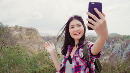 Blogger Asian backpacker woman record vlog video on top of mountain, young female happy using mobile phone make vlog video enjoy holidays on hiking adventure. Lifestyle women travel and relax concept.
