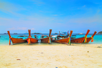 Long tailed boat at  kho lipe satun Thailand/Fishing boat on the sea and blue sky background at  kho lipe satun Thailand/Tropical beach kho lipe satun Thailand wooden long tailed boat on the sea/ 
