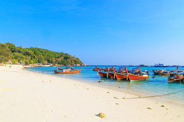 Long tailed boat at  kho lipe satun Thailand/Fishing boat on the sea and blue sky background at  kho lipe satun Thailand/Tropical beach kho lipe satun Thailand wooden long tailed boat on the sea/ 