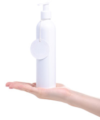 White bottle with dispenser beauty product in hand on white background isolation