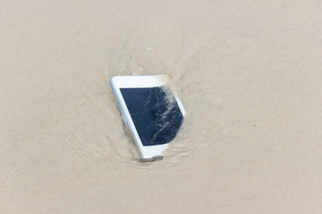 White Mobile phone floated to the sea at the beach.