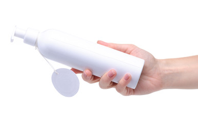 White bottle with dispenser beauty product in hand on white background isolation