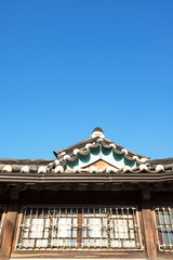 Hanok, Korean traditional house against blue sky.