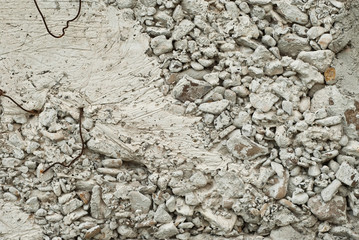 Concrete wall with gravel. Gray foundation of the house.