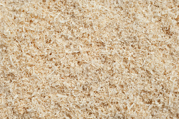 Waste wood at the factory. Thistle texture. Remains of wood after processing boards in a furniture factory.