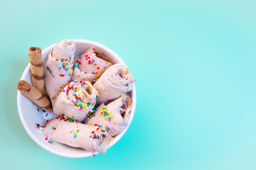 Thai ice cream roll with waffle on light blue background. Selective focus.