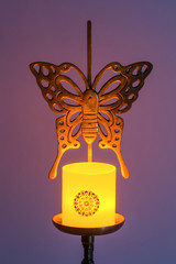 Canned on an old butterfly-shaped brass candlestick.