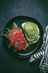 Breakfast toasts with tomatoes and avocado