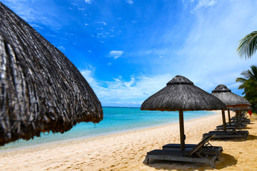 Ocean beach with cabanas blue sky white sand