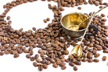 Coffee beans and antuque cup and spoons on white background