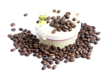 Body brush, coffee beans and oil on white background