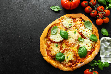 Homemade pizza with mozzarella on dark background