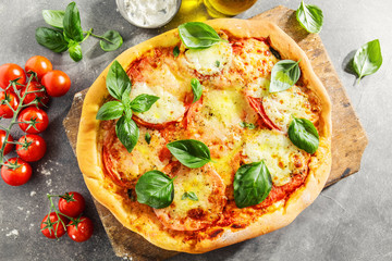 Homemade pizza with mozzarella on grey background