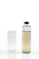Clean water in glass and dirty water in bottle glass on white background