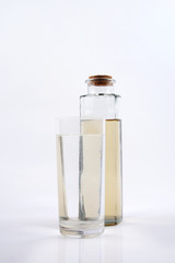 Clean water in glass and dirty water in bottle glass on white background