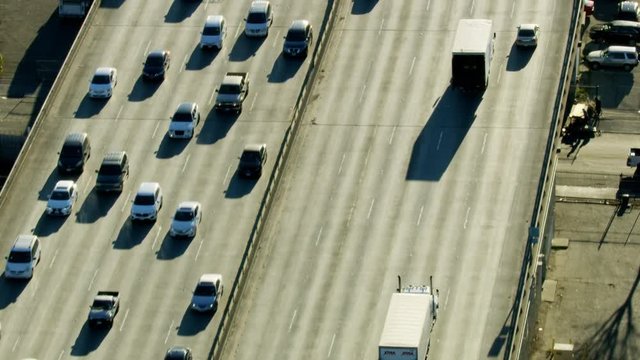 Aerial sunrise view highway traffic travelling around LA
