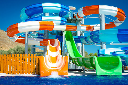 colorful open-air water slides, Detail of the orange and green slides, front view